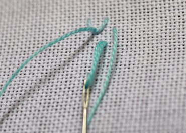 Step 2 in working single feather stitch