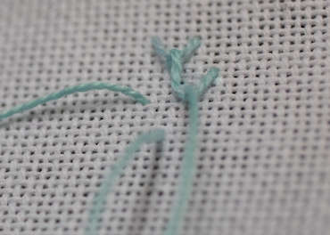 Step 3 in working single feather stitch